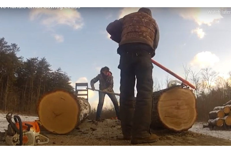 How We Handle Small Sawlog Loads Bren and Chuck on trailer with log.